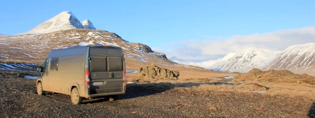 Fourgon aménagé Be-O-Be dans la plaine d'un paysage montagneux